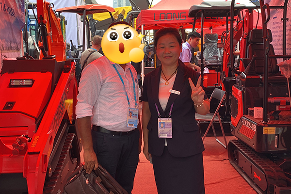 International visitors checking Loongsheen excavator digger lineup at exhibition