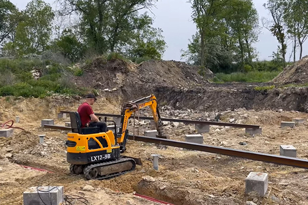 Compact excavator digger trenching for utility and municipal construction work