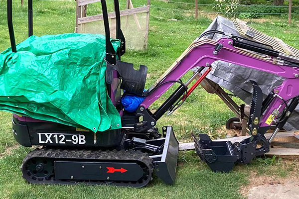 Mini excavator digger with bucket on site for drainage and trenching projects